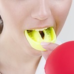 Girl placing yellow mouthguard