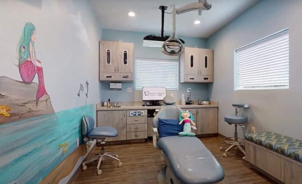 Interior 12 Pediatric dental operatory with treatment chair, cabinetry, and child-friendly decor in modern clinic setting.